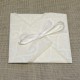 Partecipazione di nozze a origami con carta decoro, nastrini di organza e raso. Interno di carta seta.