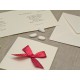 Wedding card in mulberry paper with red satin bow with polka dots