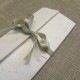 Participation booklet cross natural mulberry paper, organza and satin ribbons.