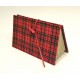 Document holder with compartments lined with tartan fabric closure leather lace and red frogging closed.