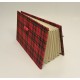 Document holder with compartments lined with tartan fabric closure leather lace and red frogging closed.