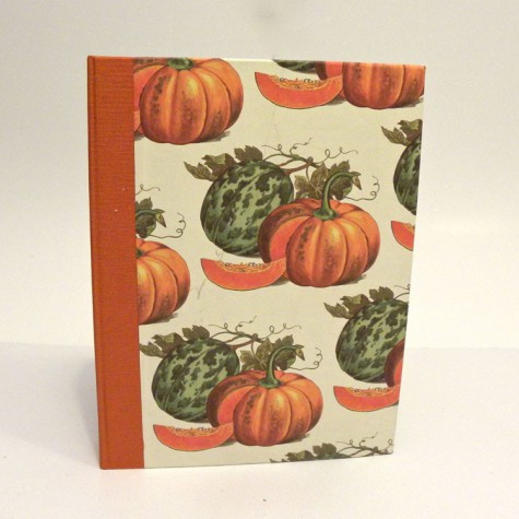 Cookbook made with paper prints with pumpkins and orange canvas back